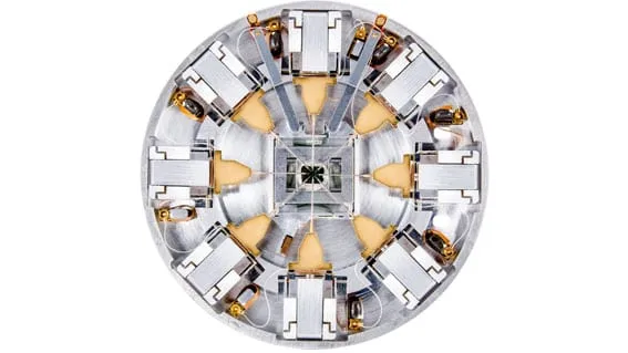 SEM image of eight nanoprobe tips converging on a patterned chip surface, 200 nm scale bar.