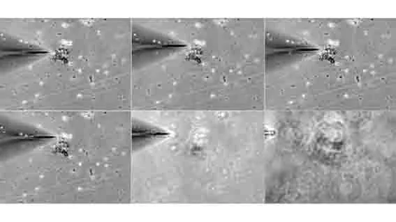 A sharp glass needle on a micromanipulator dissecting a chromosome.