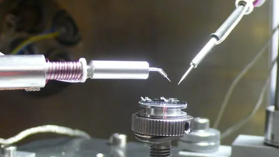 In-chamber view of the MSU mounted on the manipulator with a white ceramic-like heater element visible above the sample stage.
