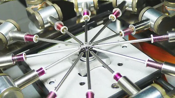 Overhead view of about a dozen MM3A-EM manipulators arranged radially around a central sample position.