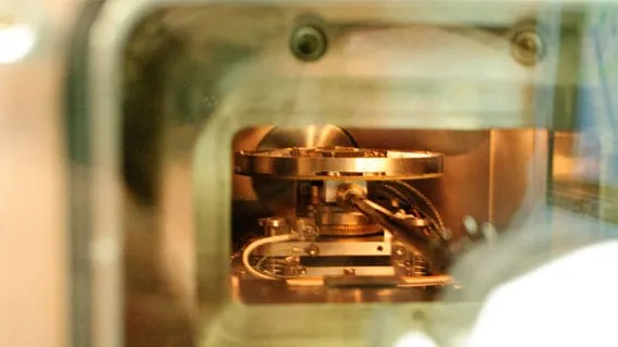 The PS4 platform viewed through a vacuum chamber viewport, mounted and ready for probing.