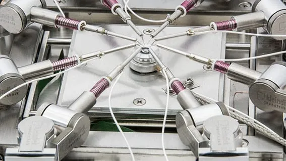 Eight manipulators converging on a sample at the centre of the ProbeWorkstation+ substage.