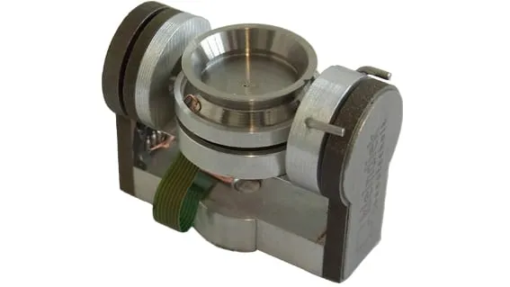 The RETE encoded tilt and rotation stage — a stainless-steel unit with two knurled drives flanking a central circular sample seat and a ribbon-cable connector.